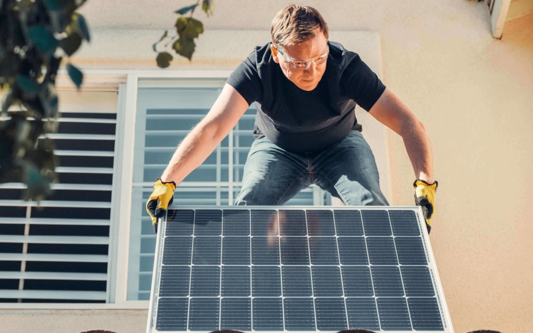 man fitting solar panels